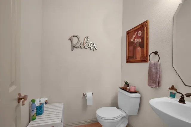 a bathroom with a toilet and a mirror