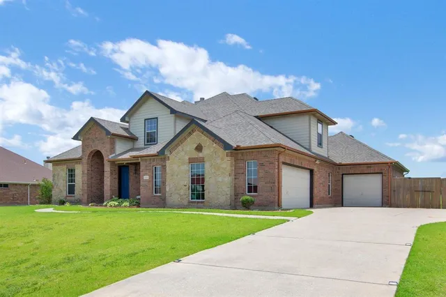 a view of a yard in front of a house with a small yard
