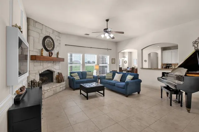 a living room with furniture a fireplace and a flat screen tv