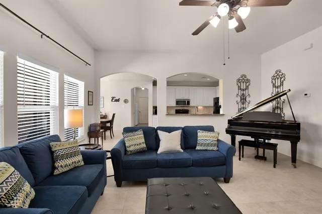 a living room with furniture and a chandelier