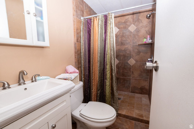 855 East 300 N Street Beaver, UT 84713 - Photo 29 of 44 Bathroom featuring a white vanity with an integrated sink, brushed nickel faucet, and a wall-mounted medicine cabinet