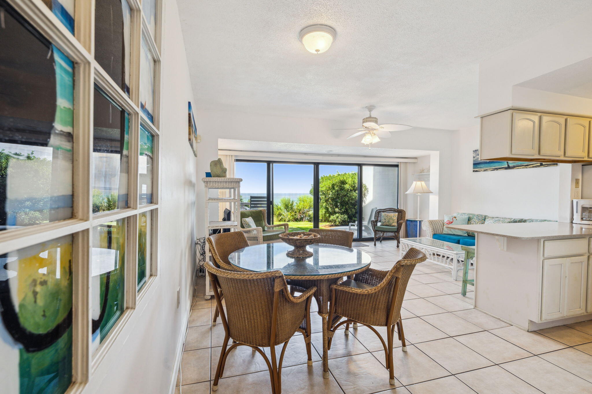 3722 East County Highway 30A, Unit 3 Santa Rosa Beach, FL 32459 - Photo 13 of 22 a dining room with furniture a rug and a floor to ceiling window