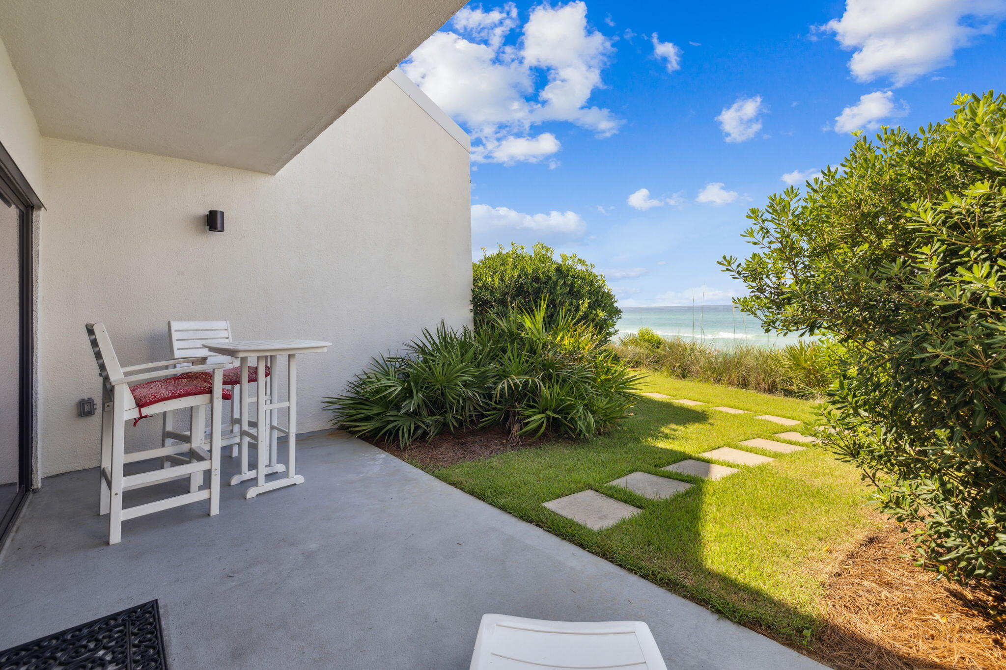 3722 East County Highway 30A, Unit 3 Santa Rosa Beach, FL 32459 - Photo 17 of 22 a backyard with table and chairs and potted plants