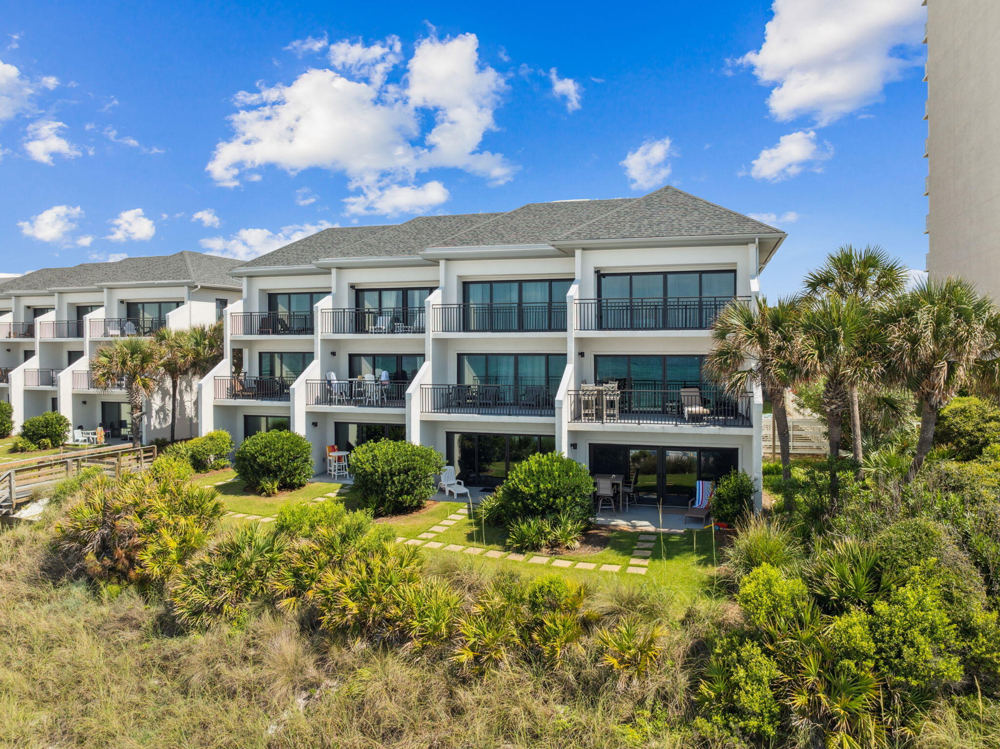 3722 East County Highway 30A, Unit 3 Santa Rosa Beach, FL 32459 - Photo 2 of 22 a front view of a house with a yard