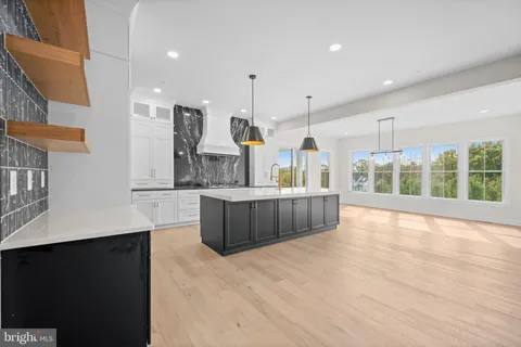 a large kitchen with a large counter top and stainless steel appliances