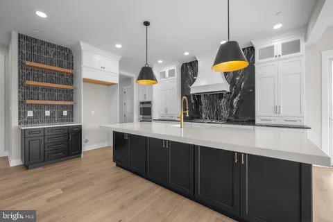 a kitchen with a sink a counter space and stainless steel appliances