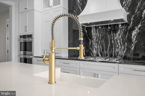 a kitchen with stainless steel appliances a sink and a microwave