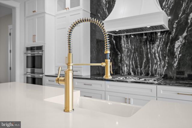 a kitchen with stainless steel appliances a sink and a microwave