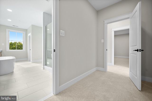 a view of a bathroom with a tub and shower