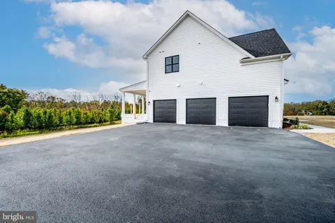a view of a house with a yard and garage