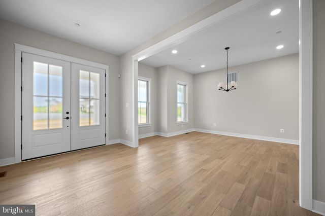 a view of an empty room with glass door and balcony