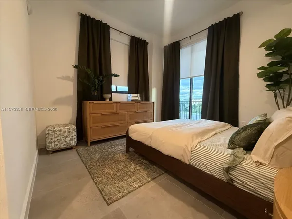 a bedroom with a bed and a potted plant