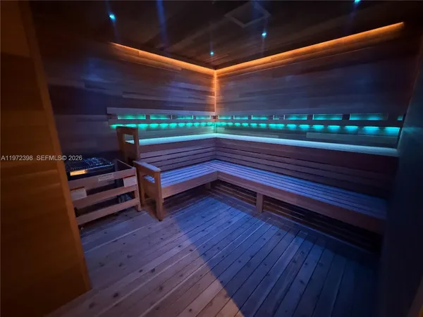 a room with wooden floor and furniture