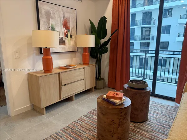 a living room with furniture and a lamp