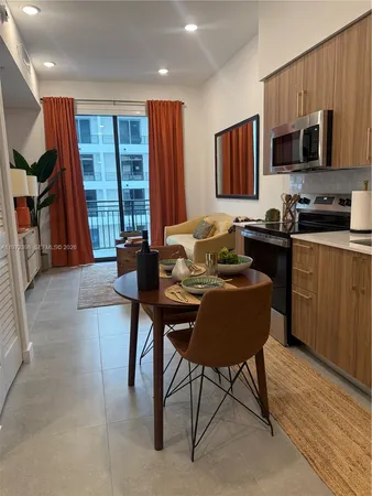 a living room with furniture a flat screen tv and large window