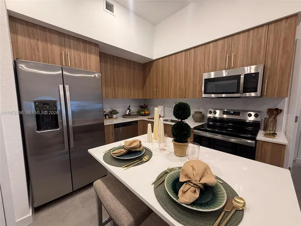 a kitchen with a sink a stove and refrigerator
