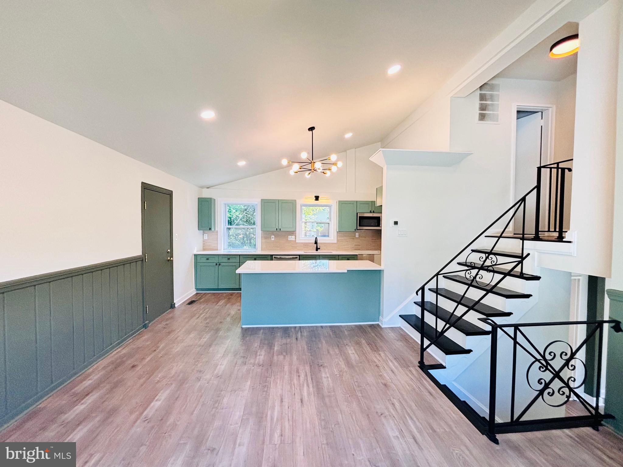 13015 Estelle Road Silver Spring, MD 20906 - Photo 11 of 38 a large kitchen with wooden floor and stainless steel appliances