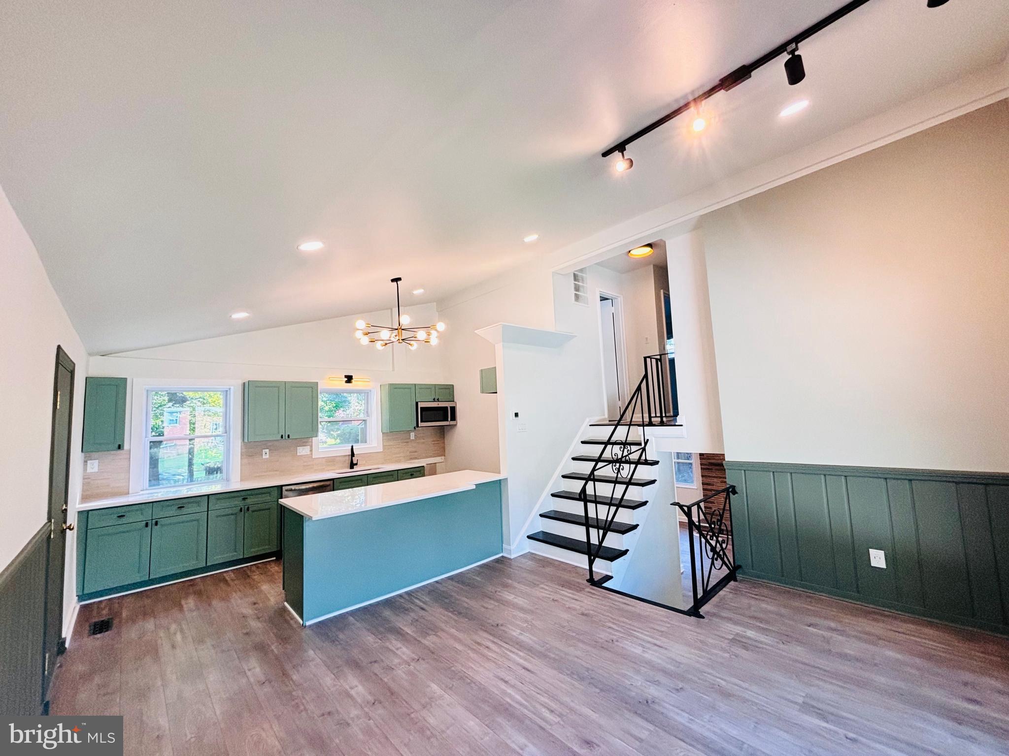 13015 Estelle Road Silver Spring, MD 20906 - Photo 12 of 38 a view of an empty room with wooden floor and windows