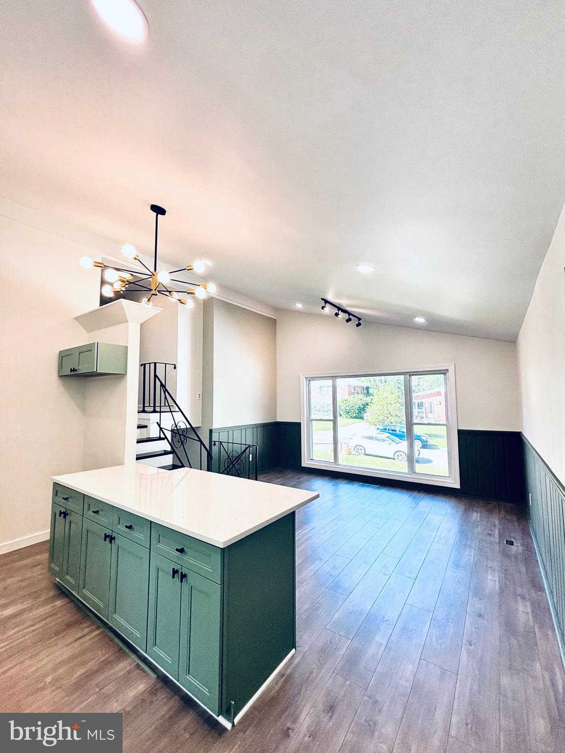13015 Estelle Road Silver Spring, MD 20906 - Photo 15 of 38 a kitchen with stainless steel appliances kitchen island a sink wooden floor and window