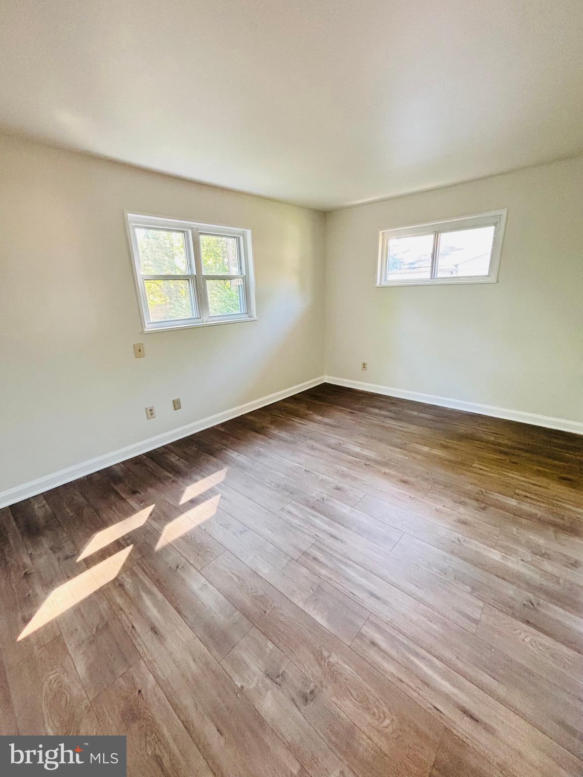 13015 Estelle Road Silver Spring, MD 20906 - Photo 19 of 38 a view of an empty room with wooden floor and a window
