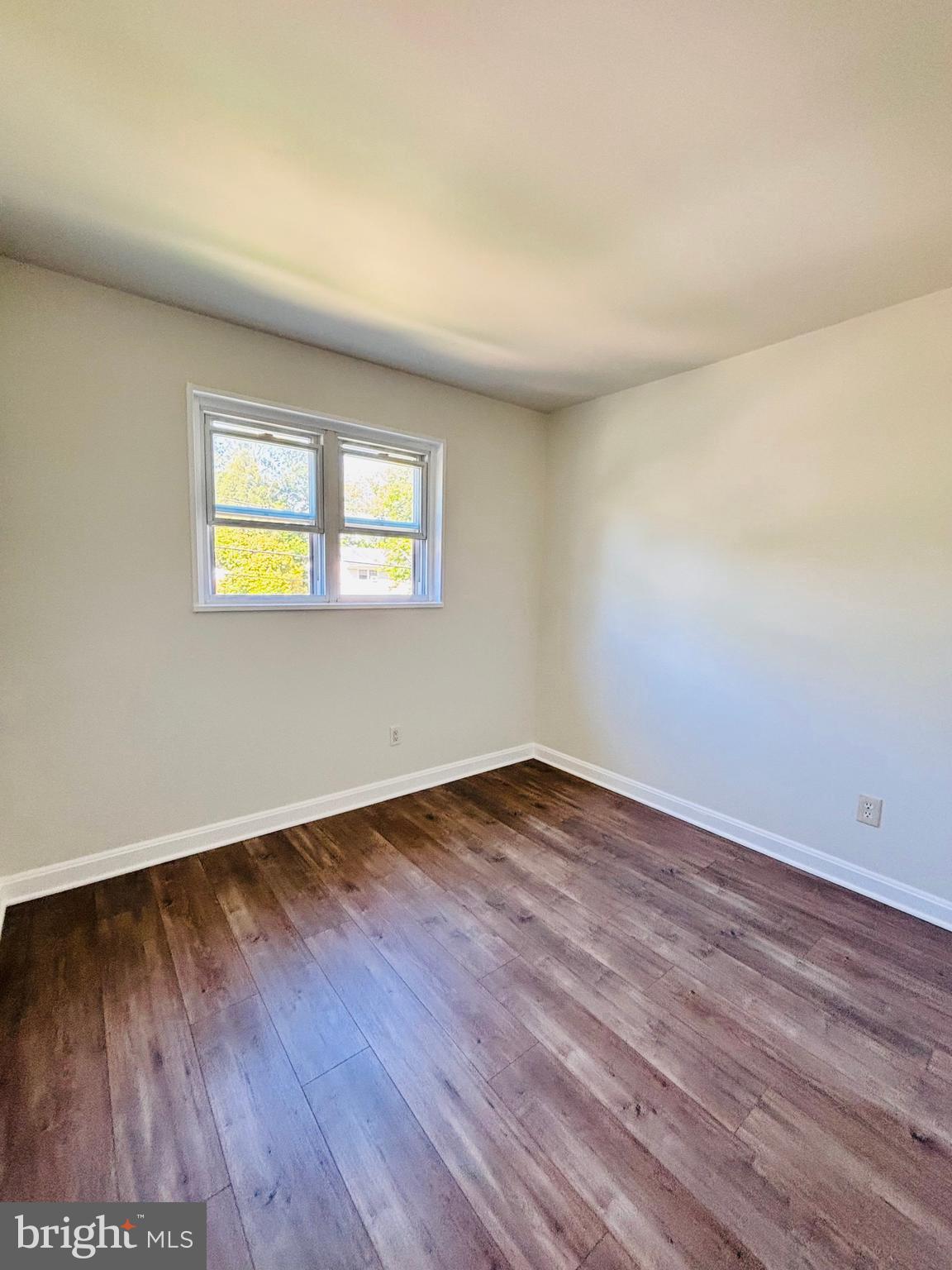 13015 Estelle Road Silver Spring, MD 20906 - Photo 22 of 38 an empty room with wooden floor and window