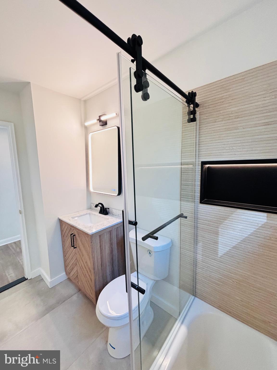 13015 Estelle Road Silver Spring, MD 20906 - Photo 26 of 38 a bathroom with a granite countertop sink toilet and shower