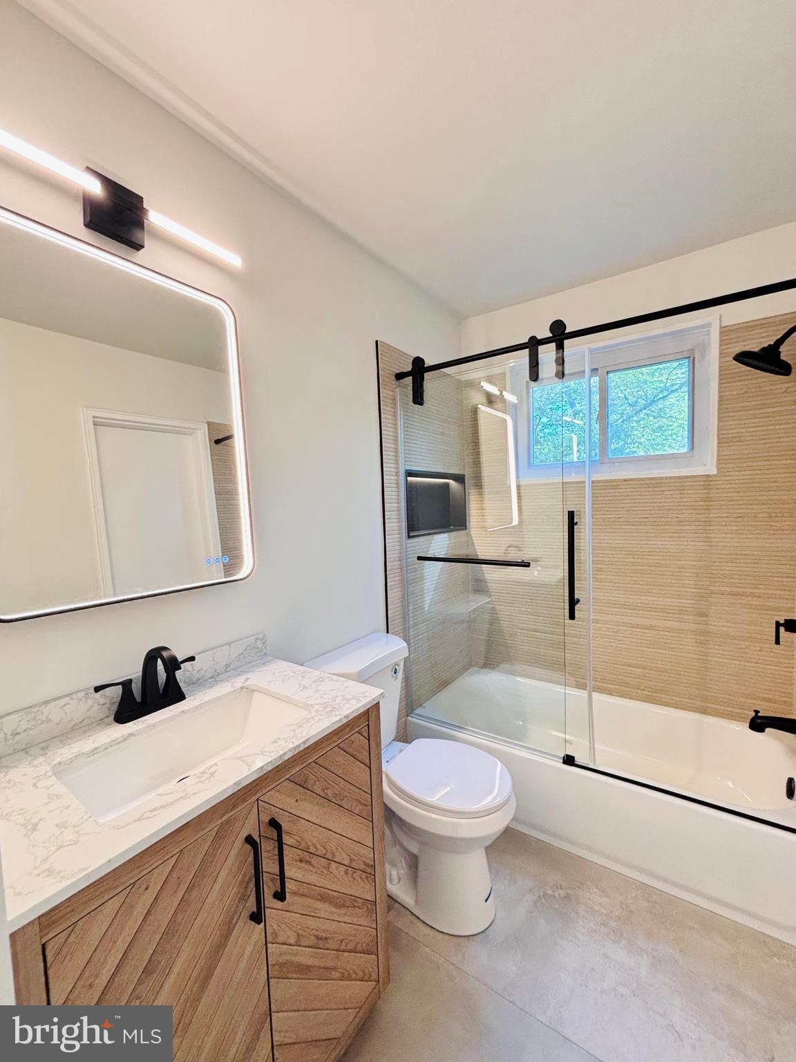 13015 Estelle Road Silver Spring, MD 20906 - Photo 29 of 38 a bathroom with a sink a toilet a mirror and shower