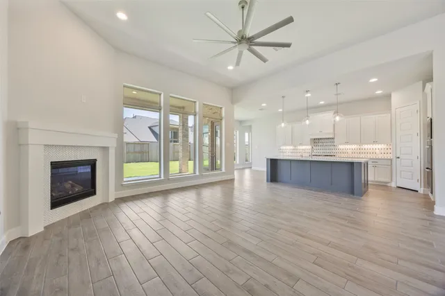 a view of an empty room with a fireplace and a window