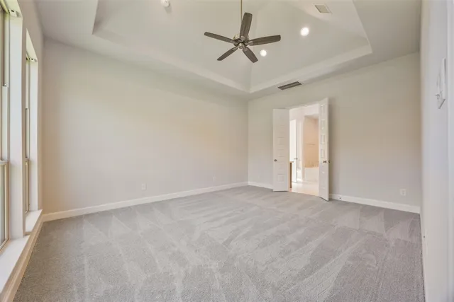 an empty room with chandelier fan