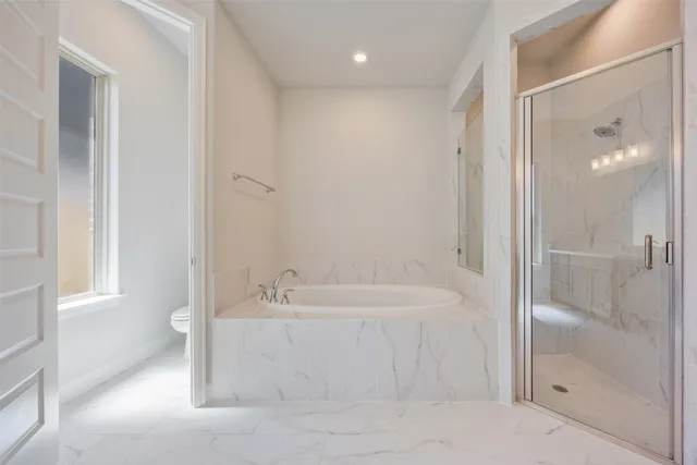 a bathroom with a bathtub and a shower