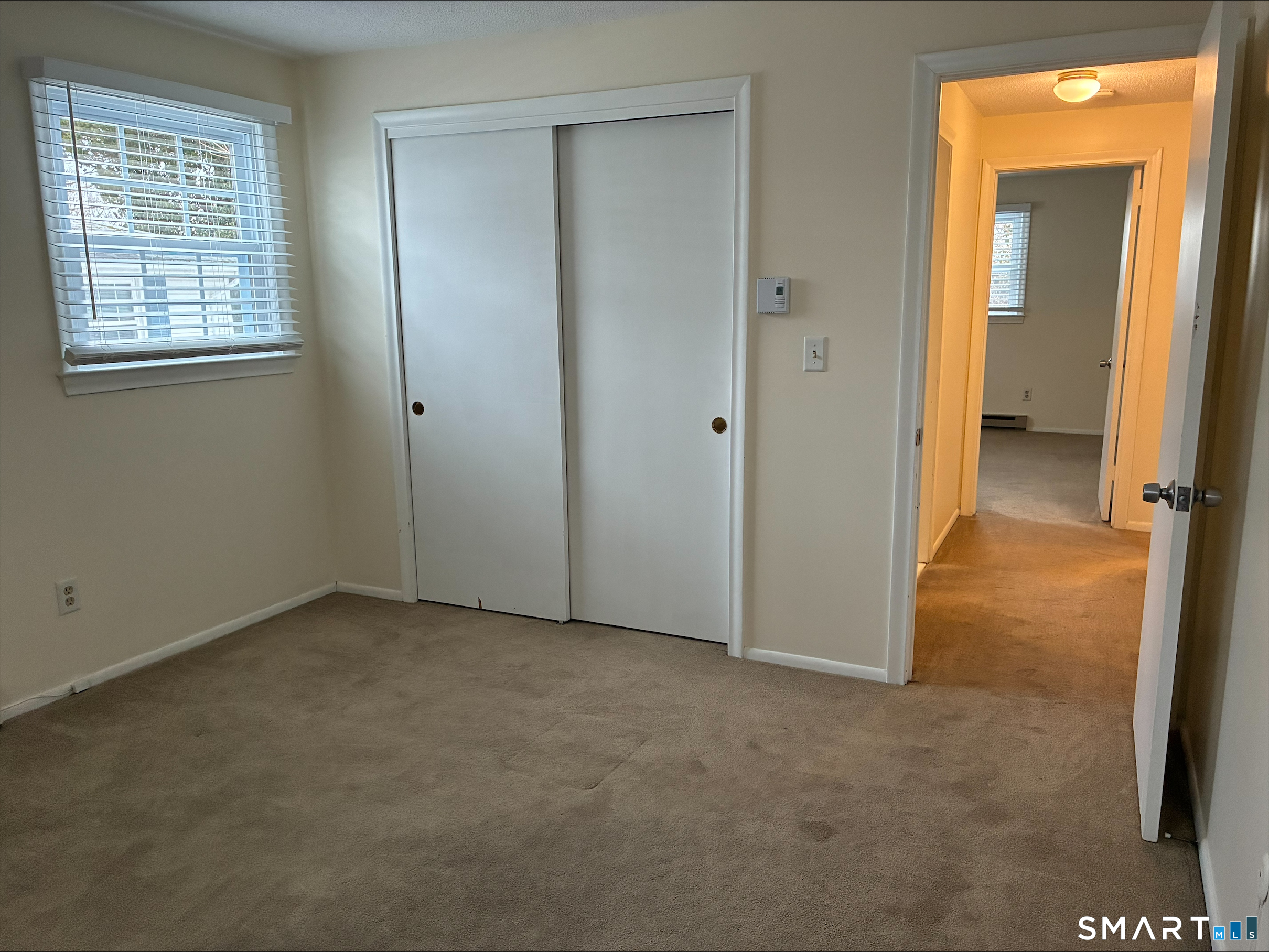 26 College Street, Unit 2 Clinton, CT 06413 - Photo 24 of 27 an empty room with windows and closet