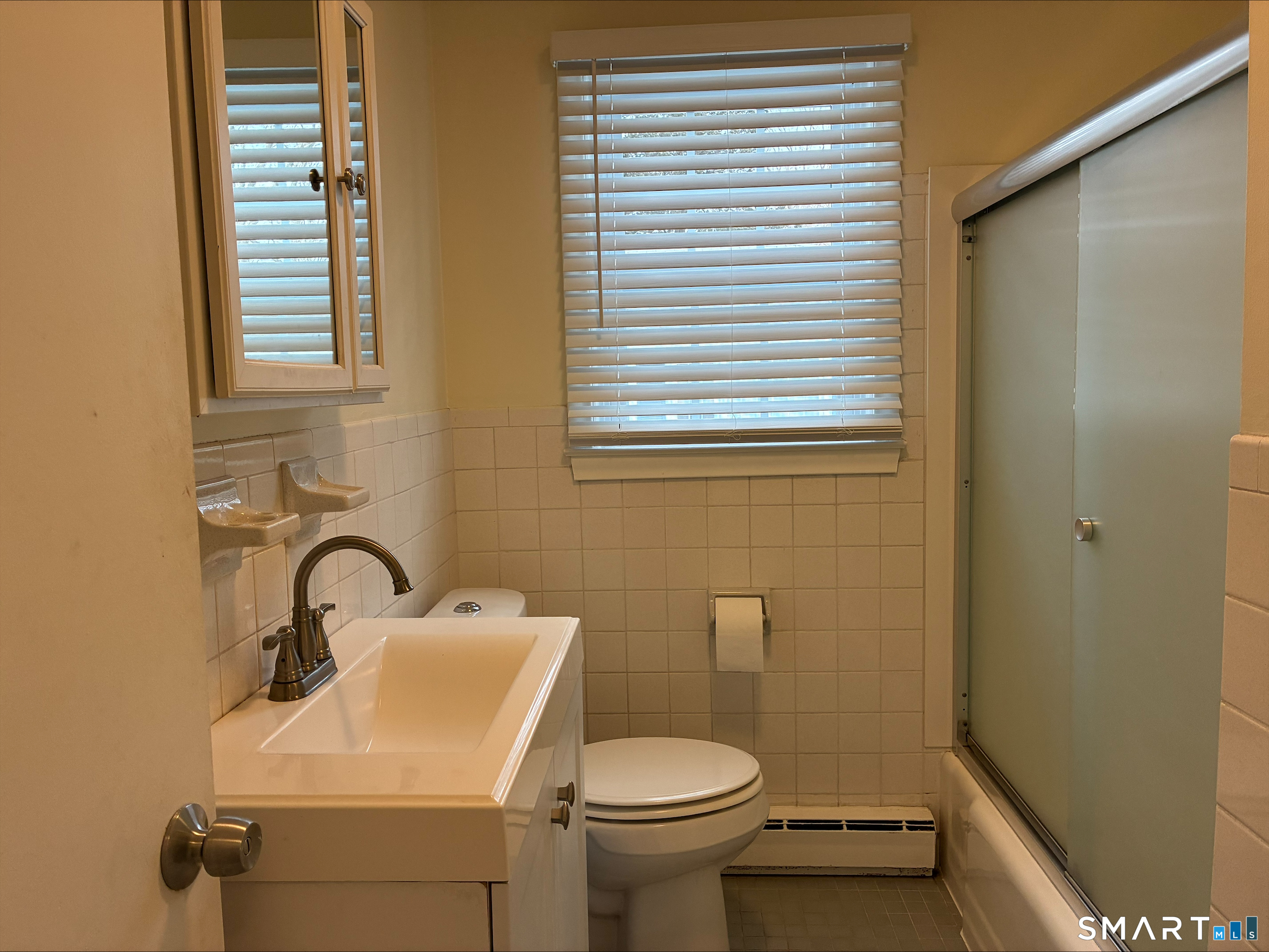 26 College Street, Unit 2 Clinton, CT 06413 - Photo 26 of 27 a bathroom with a sink a toilet and a mirror