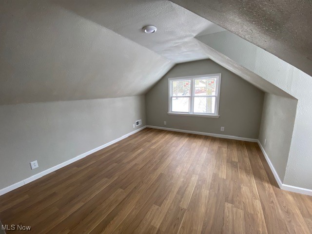 1027 Bantam Ridge Road Steubenville, OH 43953 - Photo 15 of 18 Bonus room with lofted ceiling, wood-type flooring, and a textured ceiling