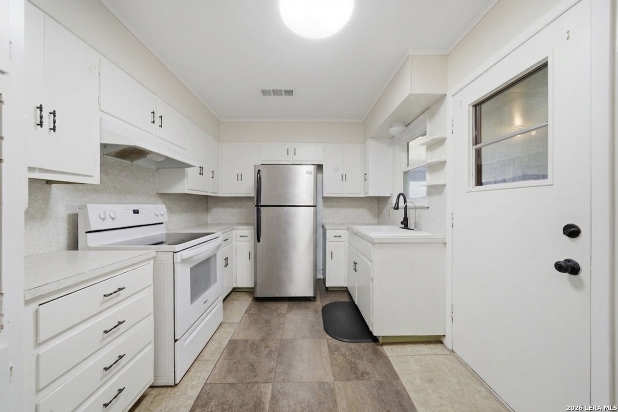 365 State Highway 95 Elgin, TX 78621 - Photo 15 of 34 a kitchen with white cabinets and white appliances