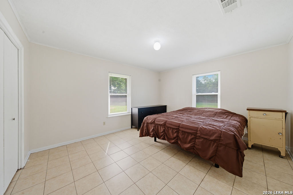 365 State Highway 95 Elgin, TX 78621 - Photo 19 of 34 a bedroom with a bed and a window