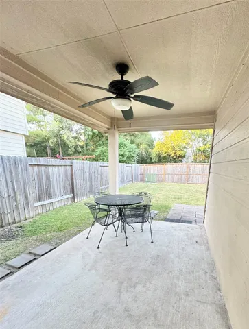 a view of a patio with a table chairs and a yard