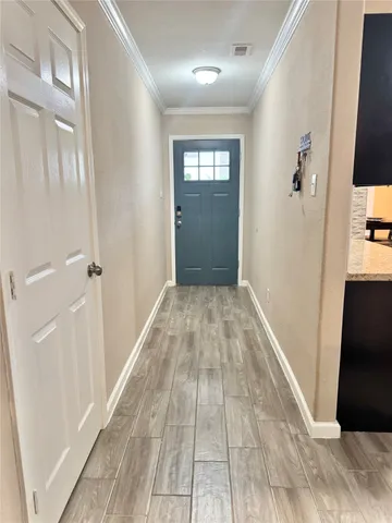 a view of a hallway view with wooden floor and staircase