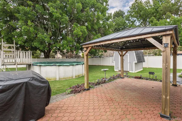 a view of a house with a yard and sitting area