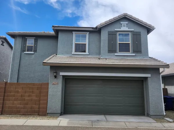 a front view of a house with garage