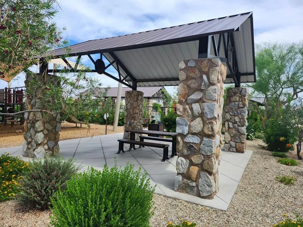 a view of a patio with couches table and chairs and potted plants