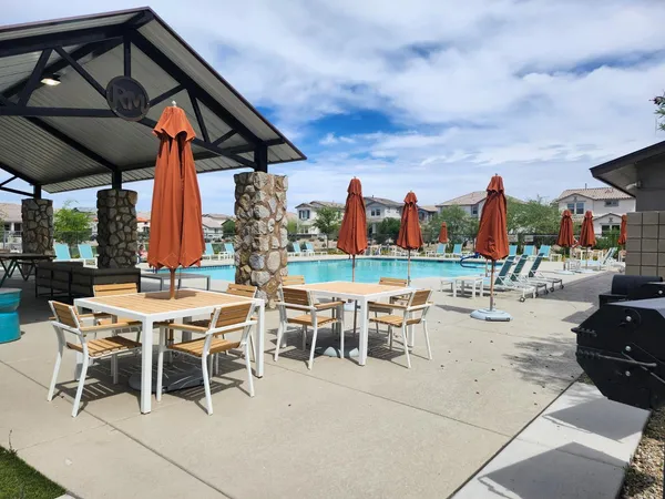 a view of a chairs and table in backyard of the house