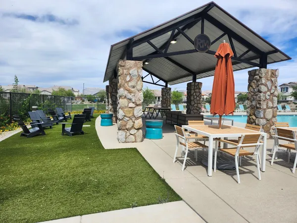 a view of a patio with a table and chairs under an umbrella