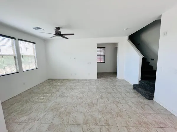 an empty room with windows and closet