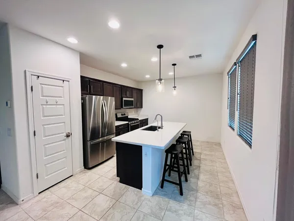 a kitchen with refrigerator and cabinets