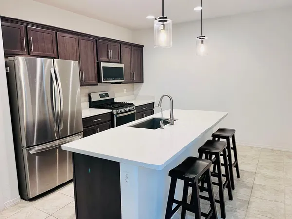 a kitchen with stainless steel appliances a refrigerator and a sink