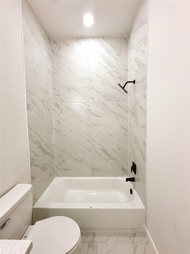 9705 Garcroft Street, Unit A Houston, TX 77029 - Photo 11 of 21 a bathroom with a toilet and a bath tub