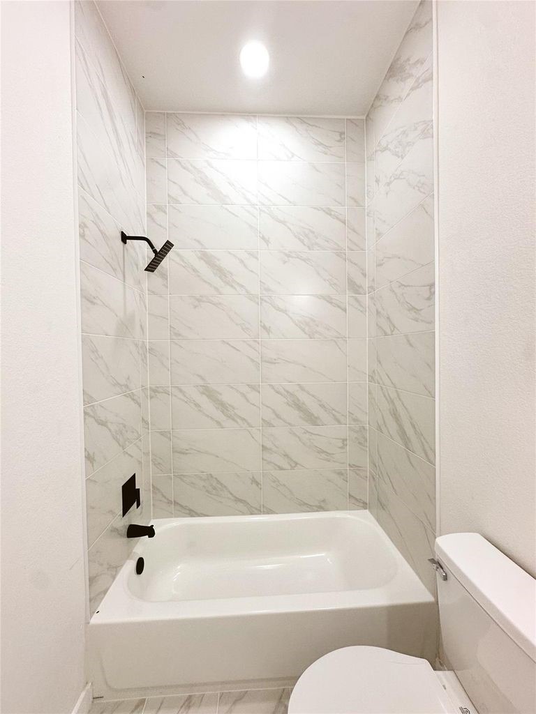 9705 Garcroft Street, Unit A Houston, TX 77029 - Photo 17 of 21 a bathroom with a bathtub and toilet