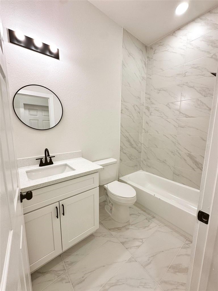 9705 Garcroft Street, Unit A Houston, TX 77029 - Photo 10 of 21 a bathroom with a sink a toilet and shower