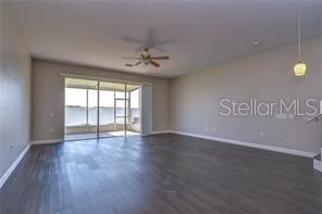 4744 Pond Ridge Drive Riverview, FL 33578 - Photo 12 of 18 a view of an empty room with window and wooden floor