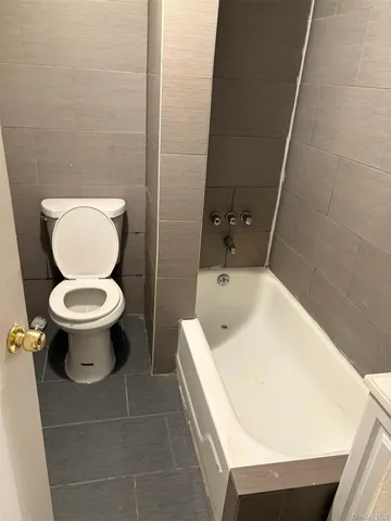 a white toilet sitting next to a white sink
